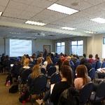 Large group of students listening to lecture